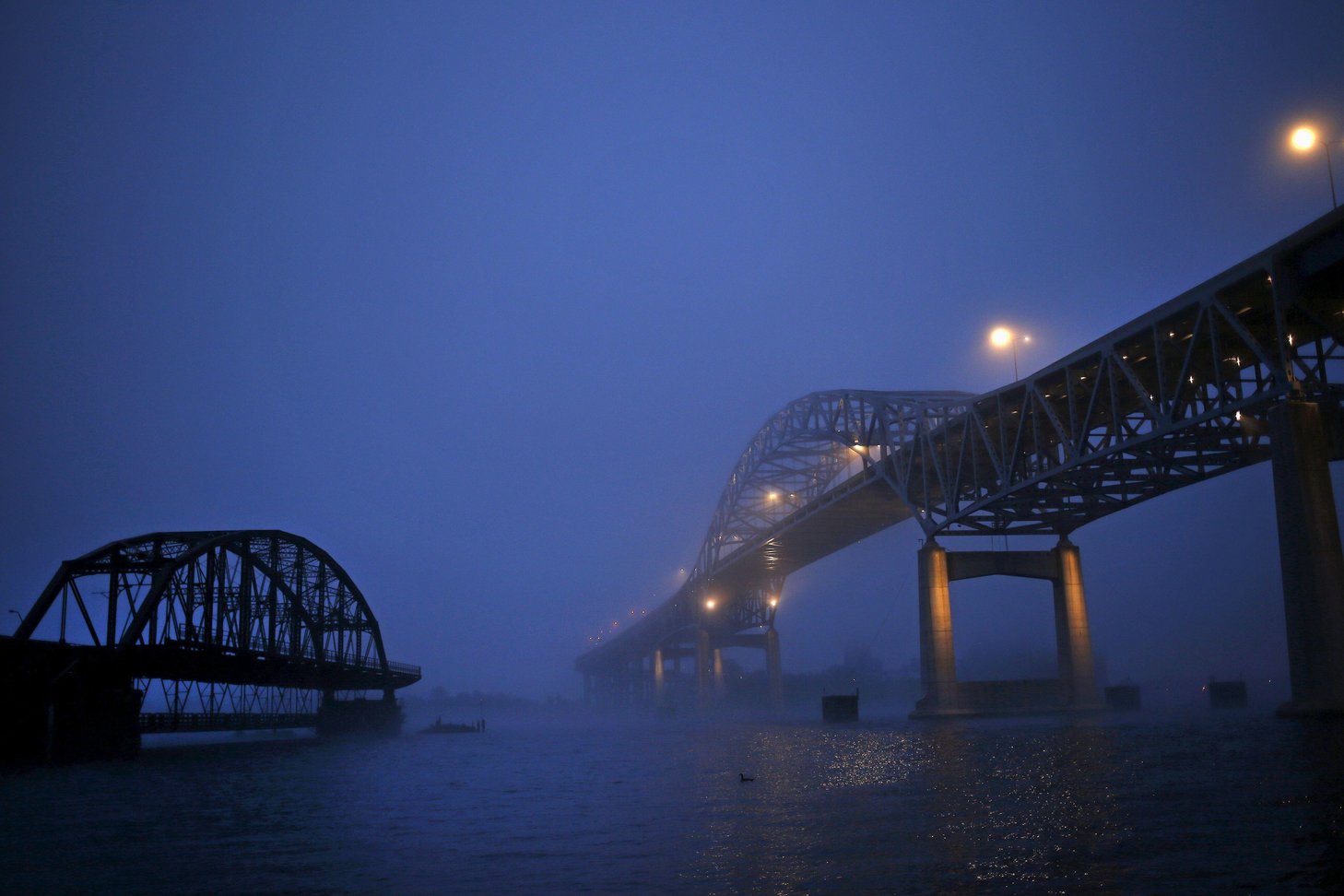 The John A. Blatnik Bridge (R) is seen through the fog crossing from Duluth, Minnesota over to Superior, Wisconsin, United States, May 28, 2015. Shortly after taking office in 2011, Wisconsin Governor Scott Walker traveled to this hardscrabble port city t